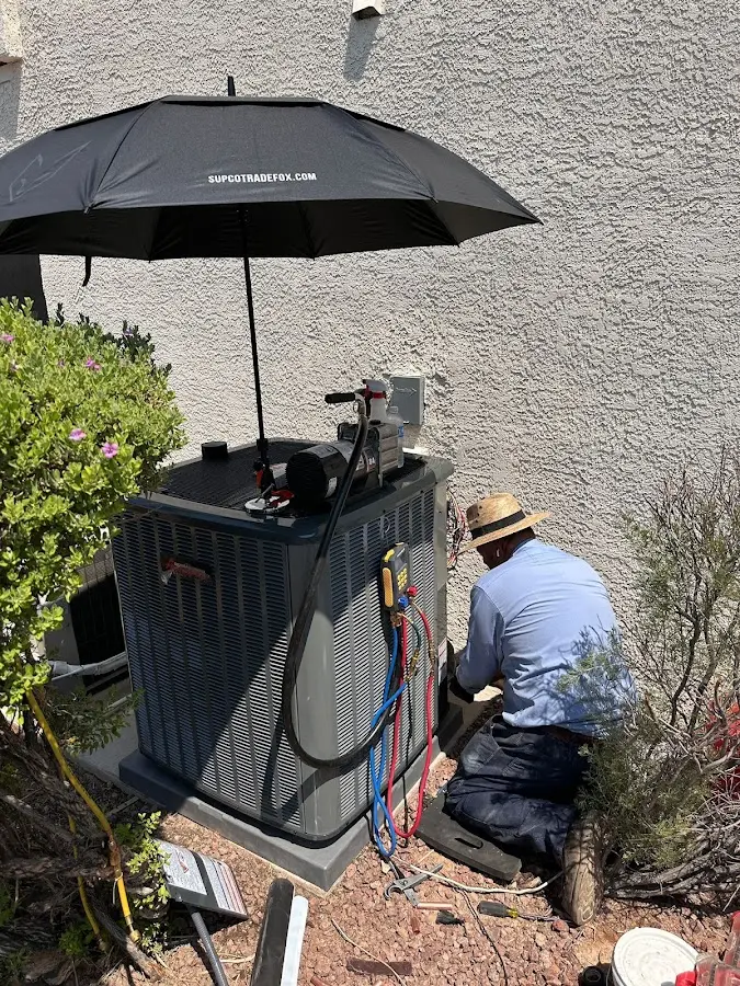 HVAC technician performing outdoor AC maintenance in Pauls Valley